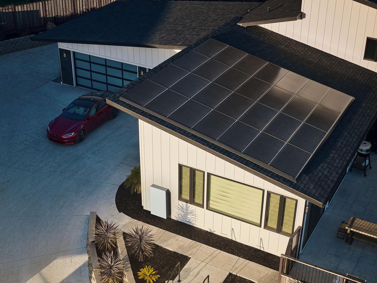 Tesla Powerwall home battery installed on the exterior wall of a house